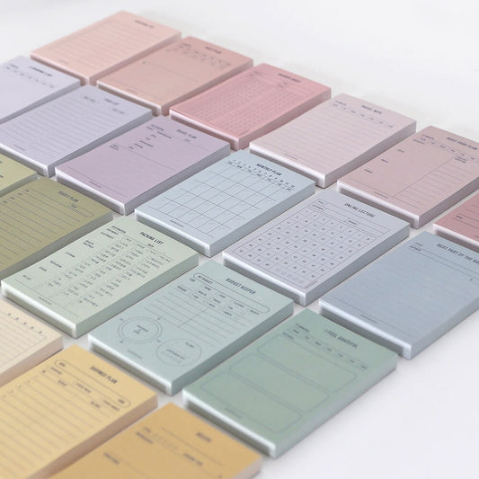 Collection of colorful notepads with various designs on the desk
