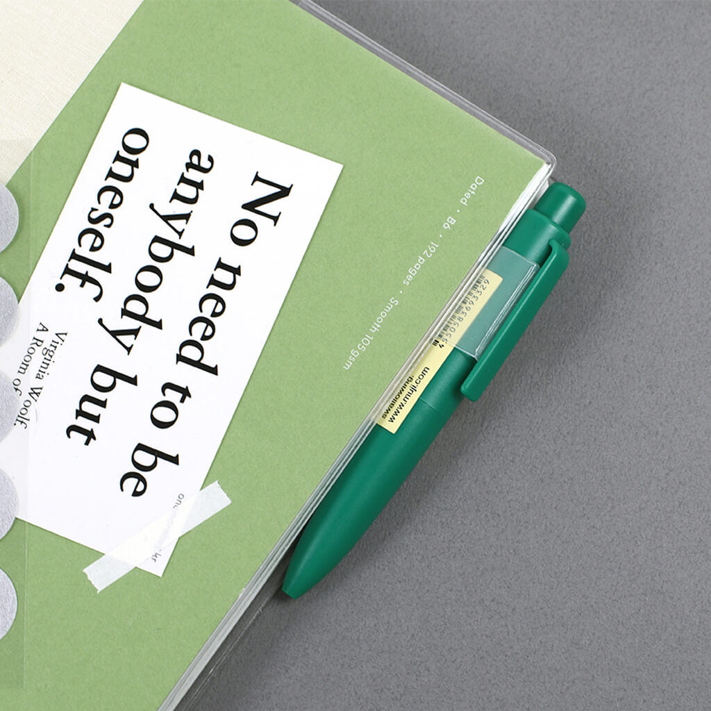 Green notebook with a pen on the pen clip, featuring a quote by Virginia Woolf.