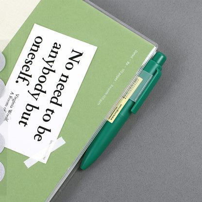 Green notebook with a pen on the pen clip, featuring a quote by Virginia Woolf.