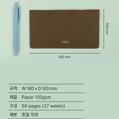 Brown planner cover with pen and dimensions on a light green background, specifying the portable or travel size of the planner- 180 mm in width and 100 mm in depth, and 56 pages for 27 weeks' record.  